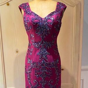 Long maroon sequin beaded prom dress with flowing bottom, keyhole back.